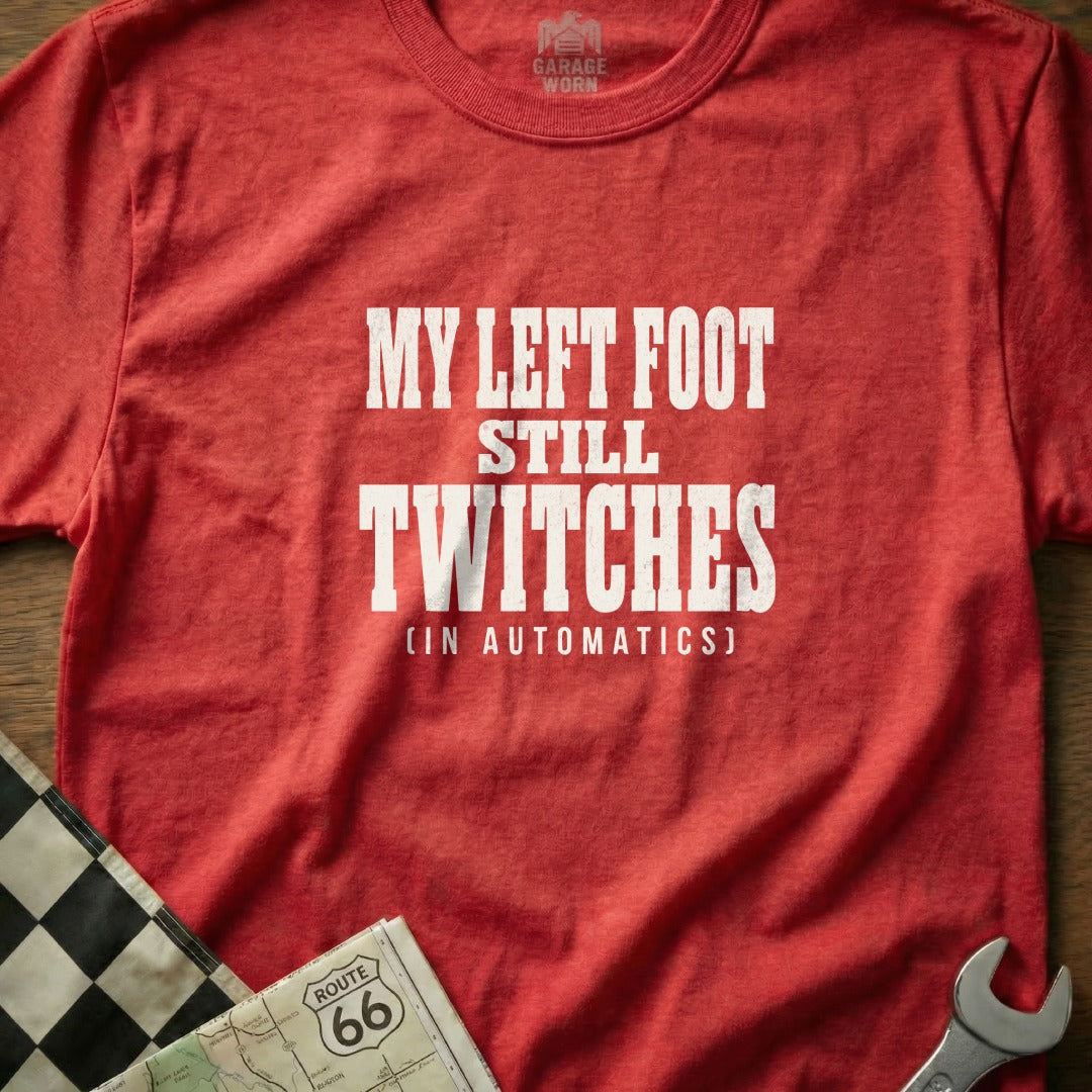 Red t-shirt with white text "MY LEFT FOOT STILL TWITCHES (IN AUTOMATICS)".