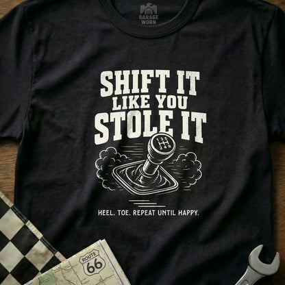 Black t-shirt with "SHIFT IT LIKE YOU STOLE IT" and gears graphic.