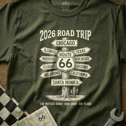 Green t-shirt with "2026 Road Trip Route 66" and directional signs to cities.