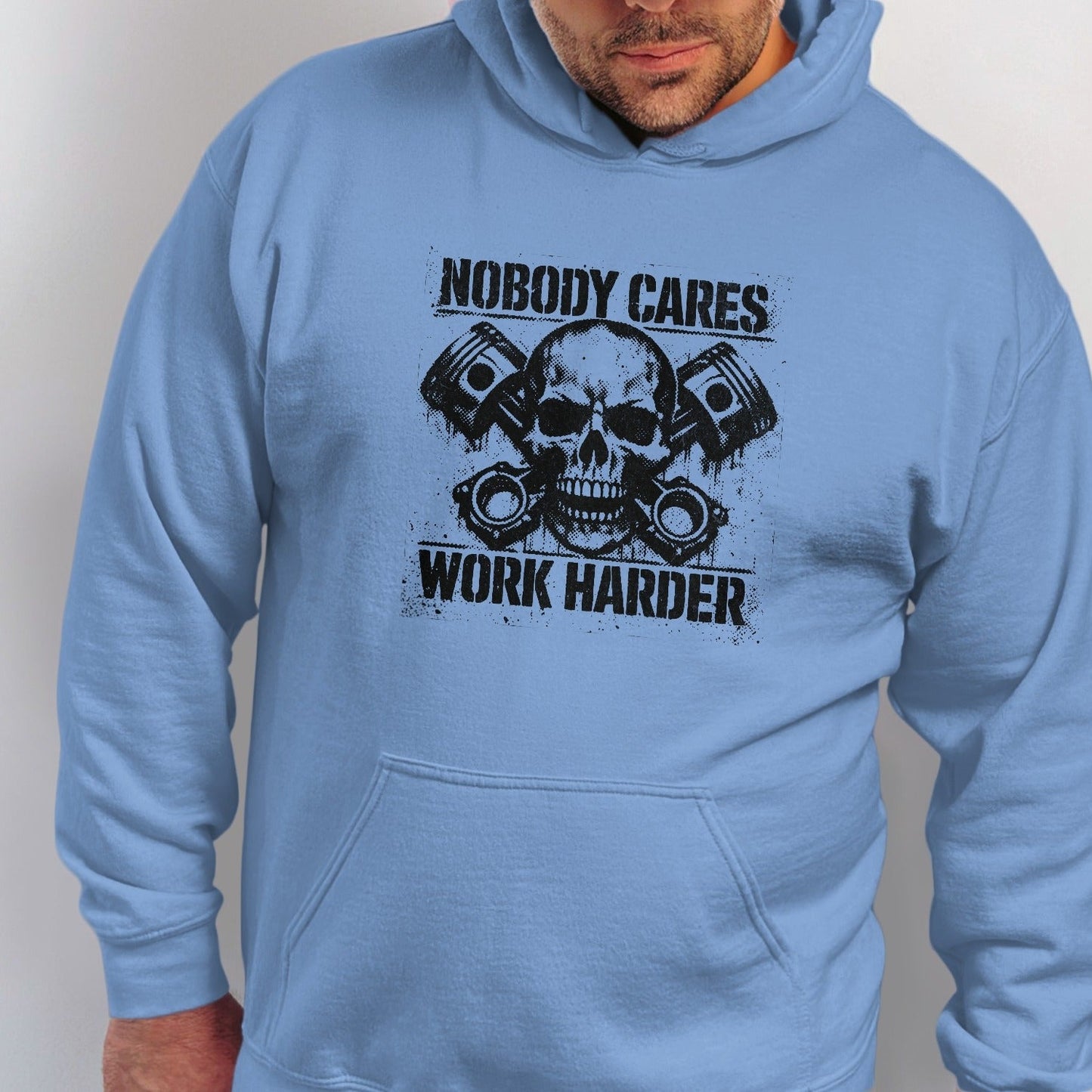 Light blue hooded sweatshirt with black graphic of skull, pistons, and text.