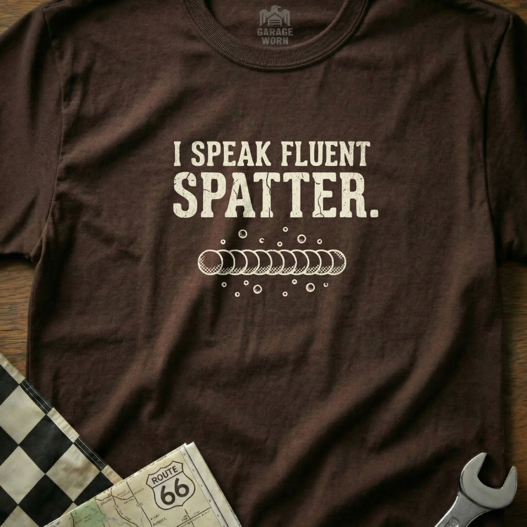 Brown t-shirt with "I Speak Fluent Spatter." text and welding bead graphic.