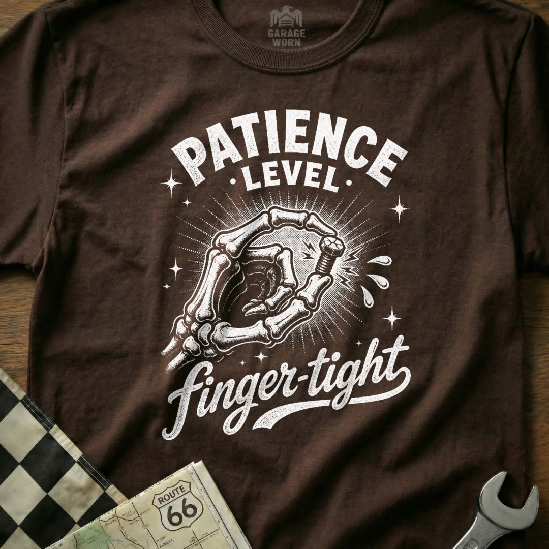 Brown t-shirt with skeleton hand twisting a bolt, text reads "Patience Level: Finger-tight".