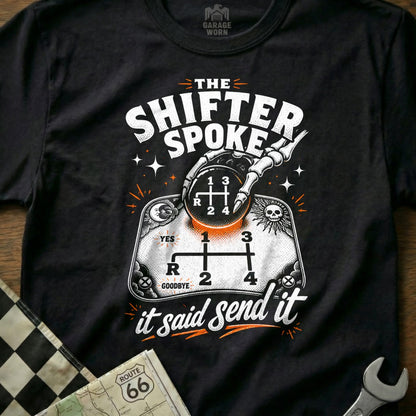 Black t-shirt with skeleton hand on gear shift, "The Shifter Spoke it Said Send It".