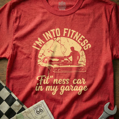 Red t-shirt with "I'm Into Fitness 'Fit' ness car in my garage" graphic.