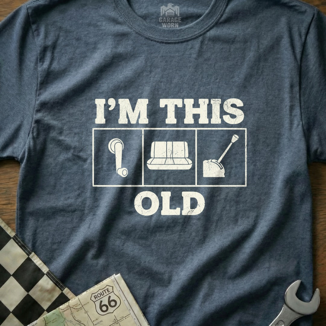 T-shirt with "I'M THIS OLD" and icons of a gear shift, car seat, and steering wheel.