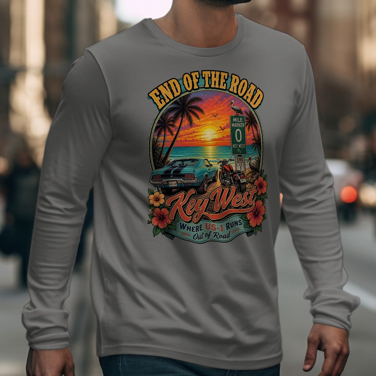 Key West end of the road graphic with car, motorcycle, and ocean sunset.