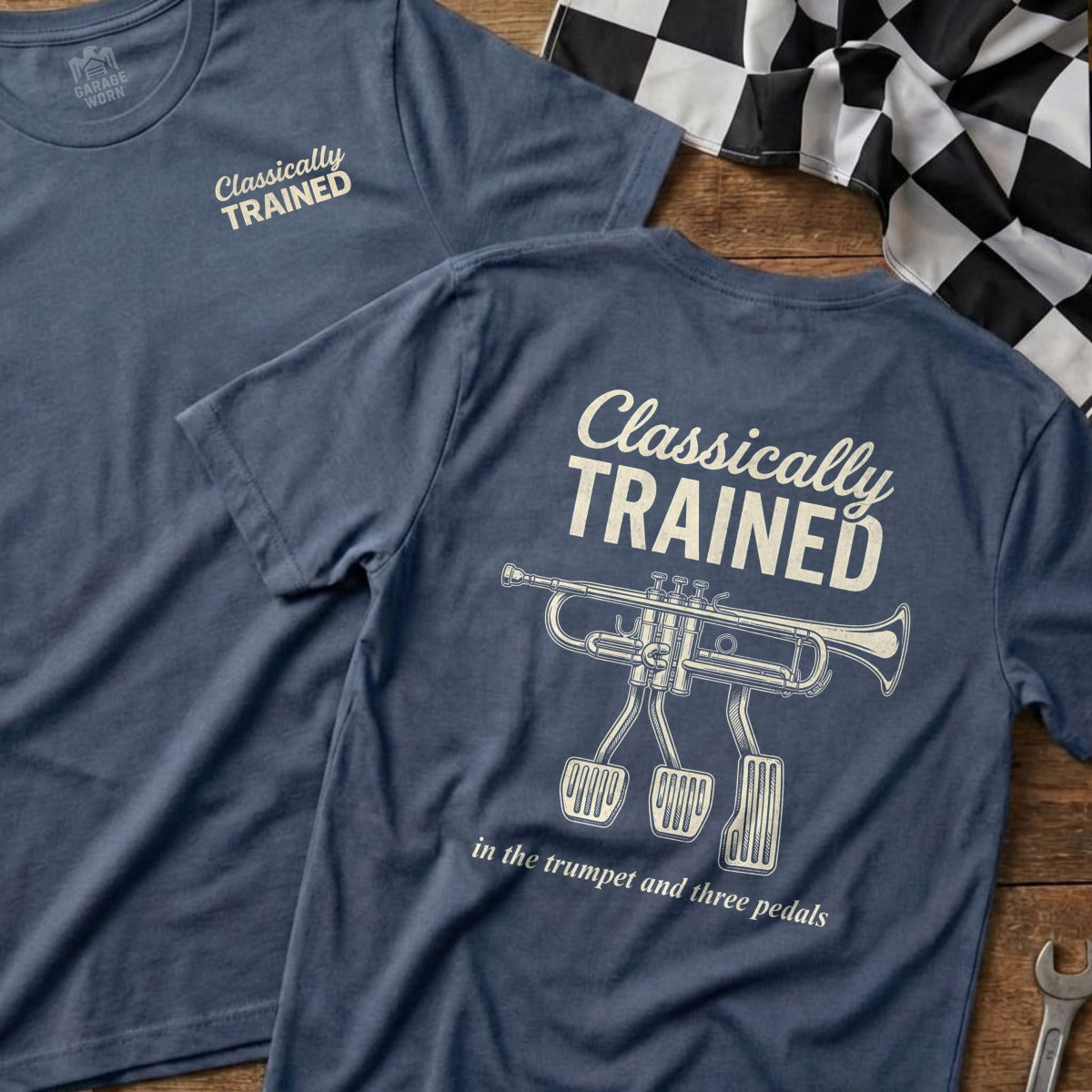 Navy t-shirt with "Classically Trained" and a trumpet with pedals.