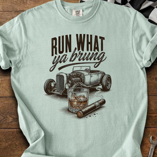 Light blue t-shirt with "RUN WHAT ya bring" text, hot rod, whiskey, and cigar graphic.