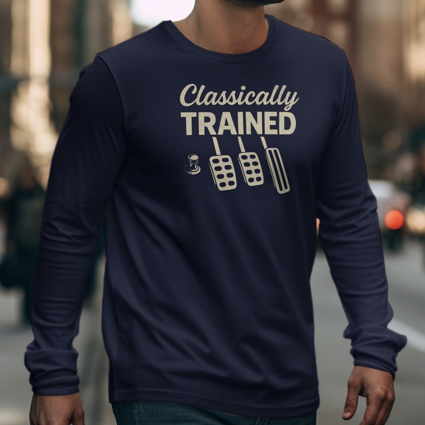 Navy long sleeve shirt with "Classically TRAINED" and three pedals graphic.
