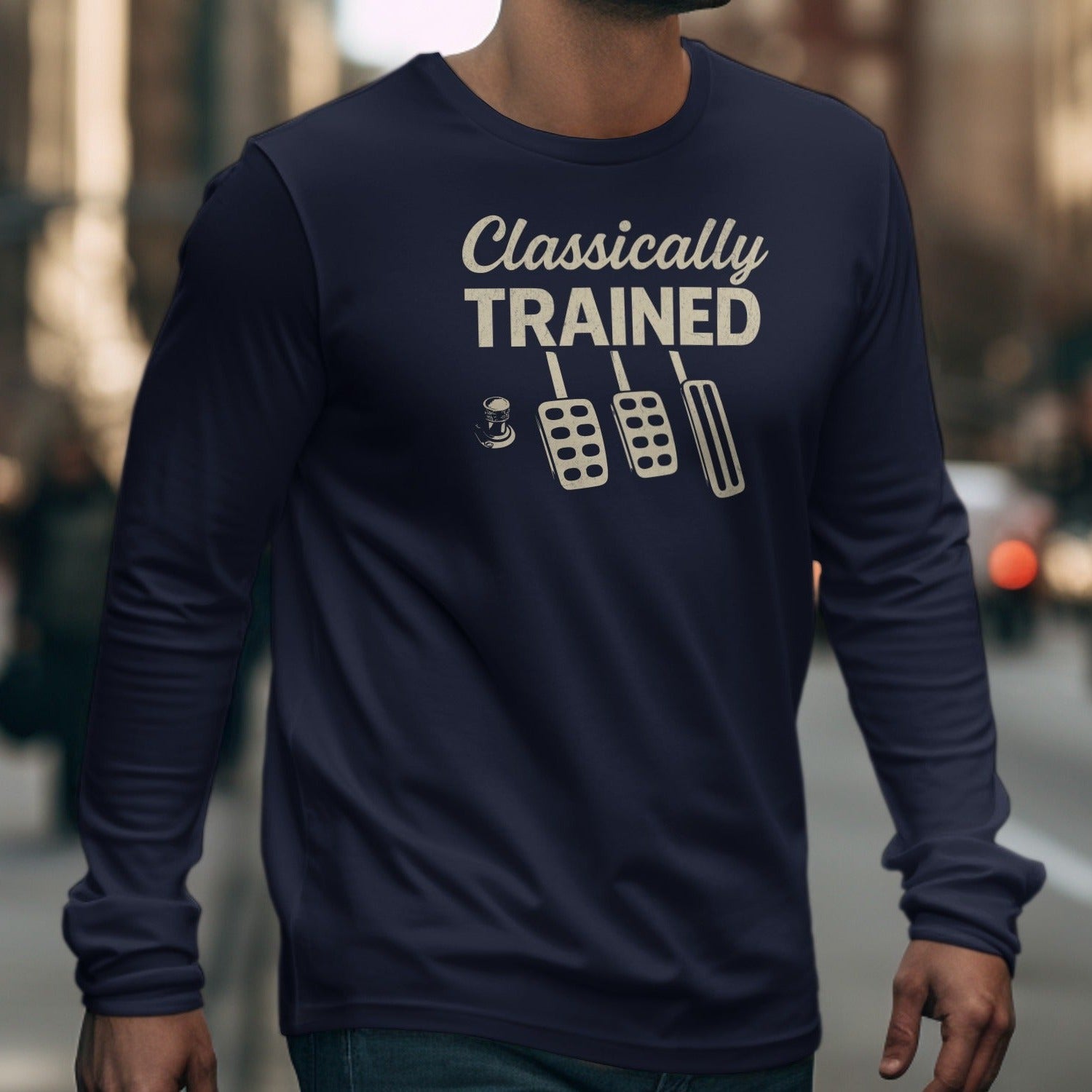 Navy long sleeve shirt with "Classically TRAINED" and three pedals graphic.
