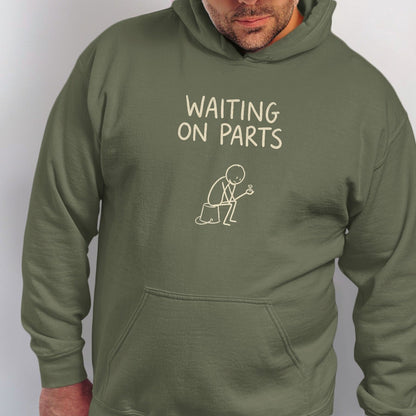 Olive green hoodie with text "WAITING ON PARTS" and stick figure holding a wrench.