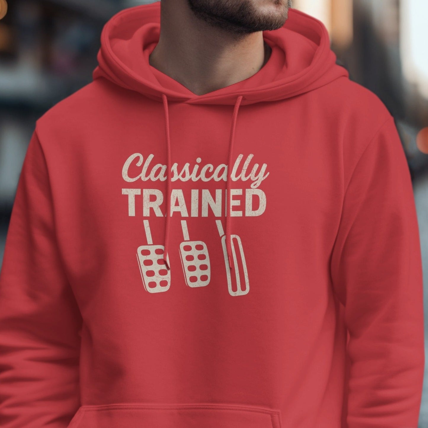 Red hoodie with "Classically TRAINED" text and three car pedals graphic.