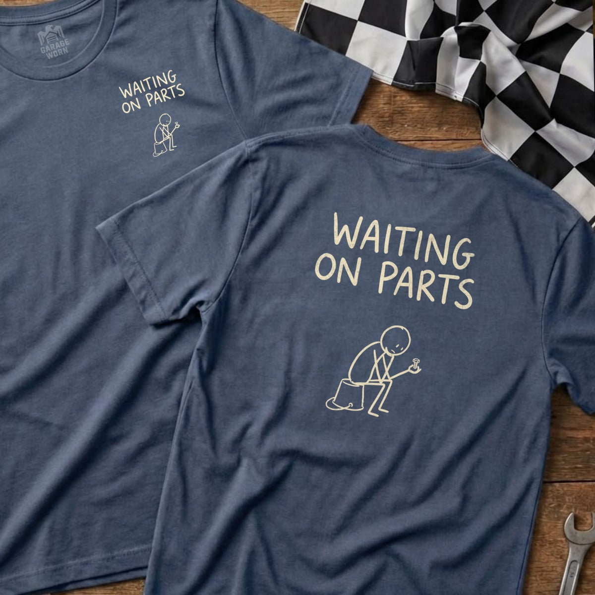 Two navy blue t-shirts with "WAITING ON PARTS" and a stick figure graphic.