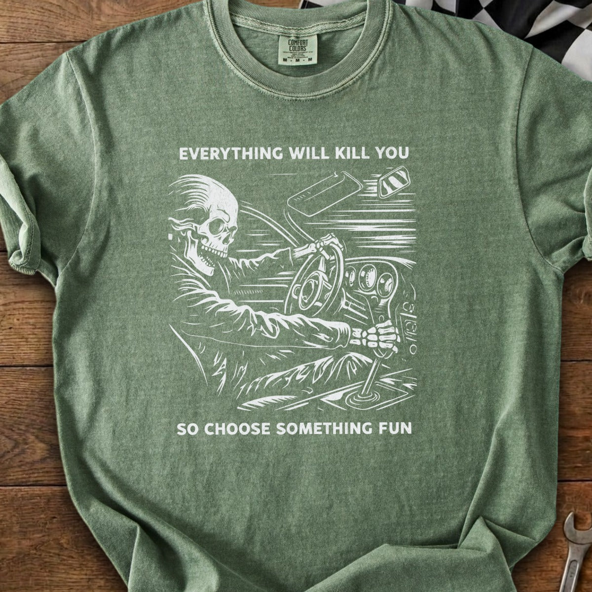 Skeleton driving a car, text reads "Everything will kill you so choose something fun."