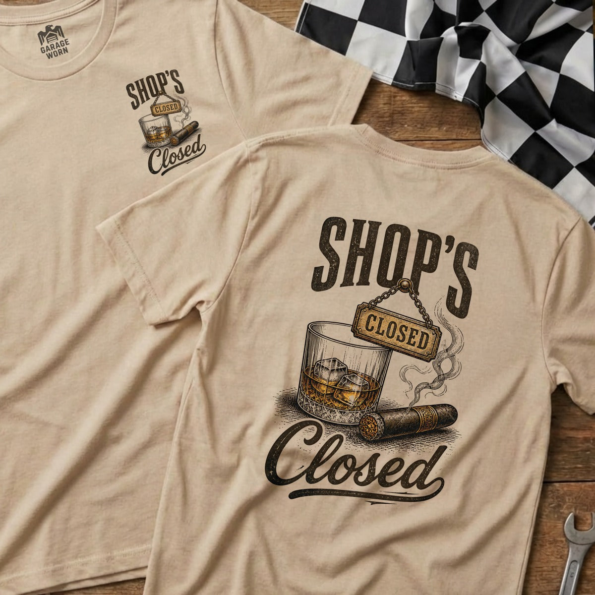Tan t-shirt featuring a graphic of a whiskey glass, cigar, and "Shop's Closed" text.