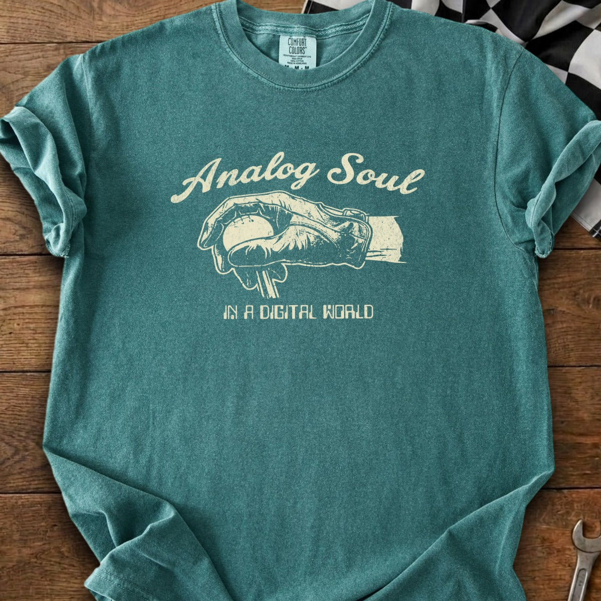 Teal t-shirt with "Analog Soul" and hand holding dial, "IN A DIGITAL WORLD".