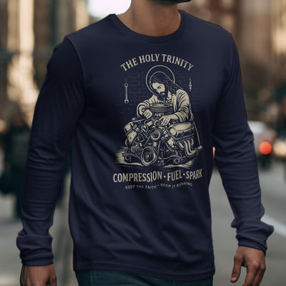 Long sleeve shirt with Jesus working on an engine, text "THE HOLY TRINITY".