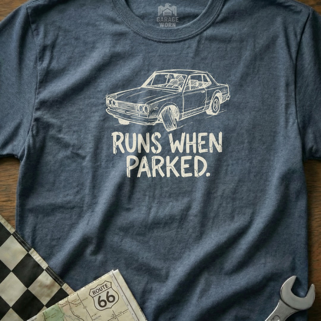 Navy t-shirt with a sketch of a classic car and text "RUNS WHEN PARKED."