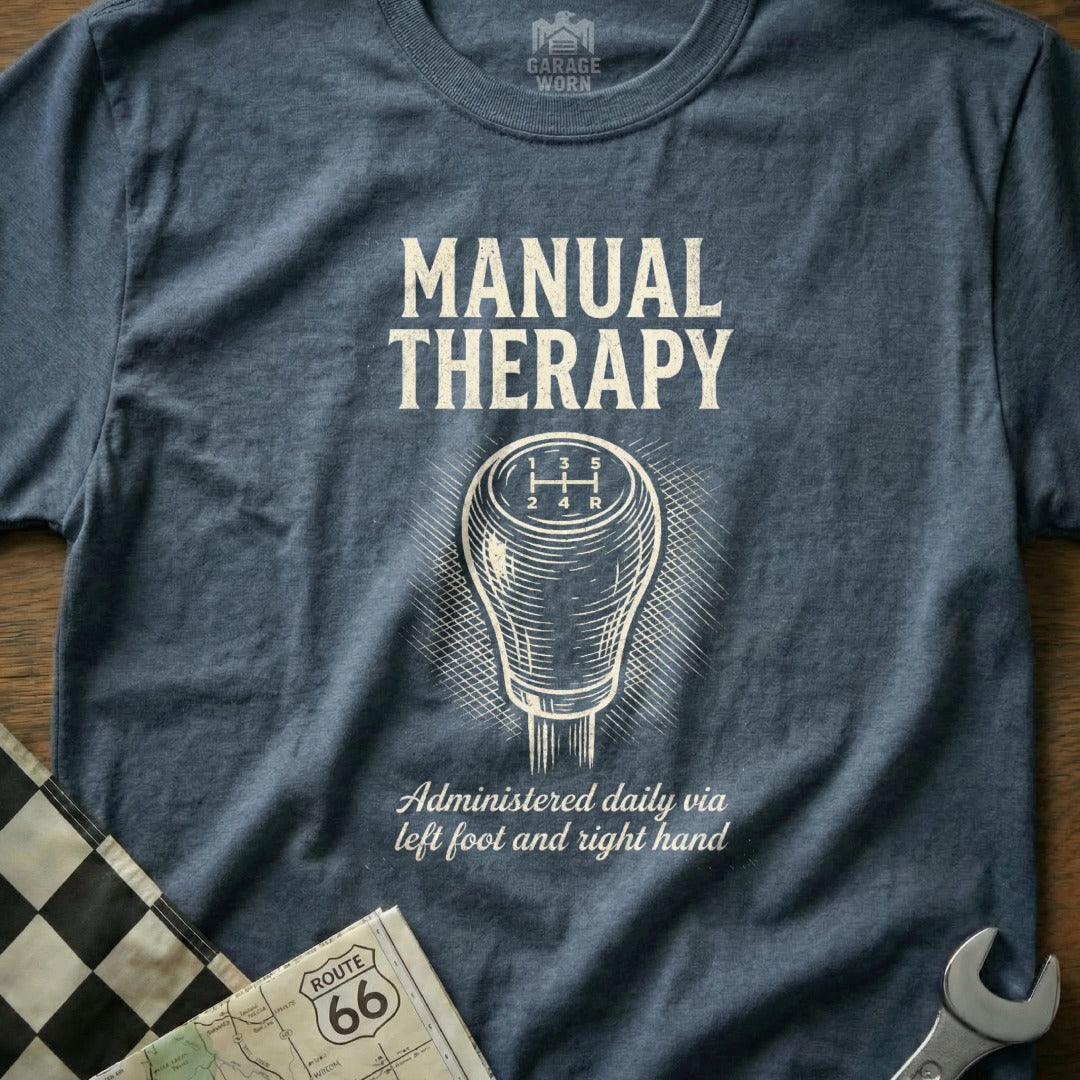 Blue t-shirt with "MANUAL THERAPY" and gear shifter graphic.