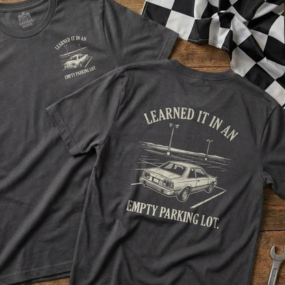 Dark t-shirt with "Learned it in an empty parking lot" and a car graphic.