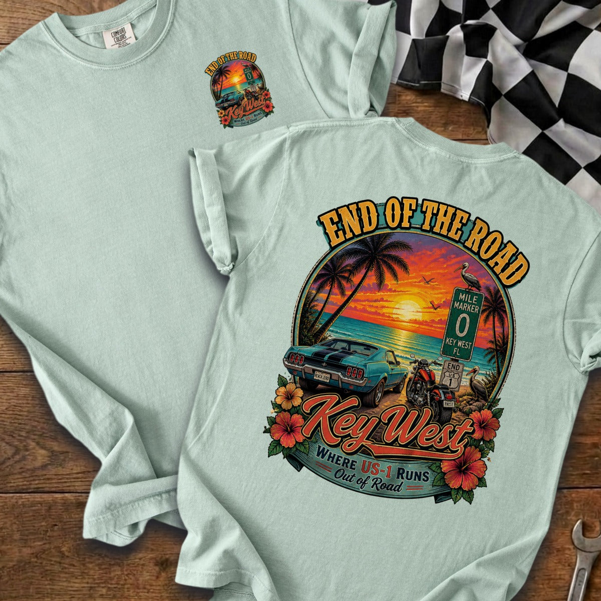 Light blue t-shirt with "End of the Road Key West" graphic featuring a sunset, car, and motorcycle.