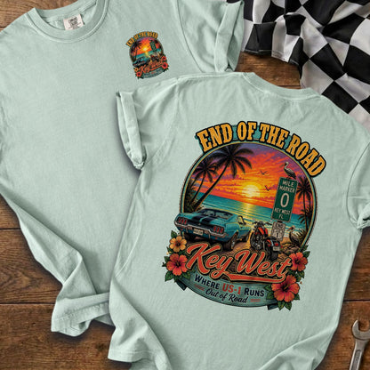 Light blue t-shirt with "End of the Road Key West" graphic featuring a sunset, car, and motorcycle.