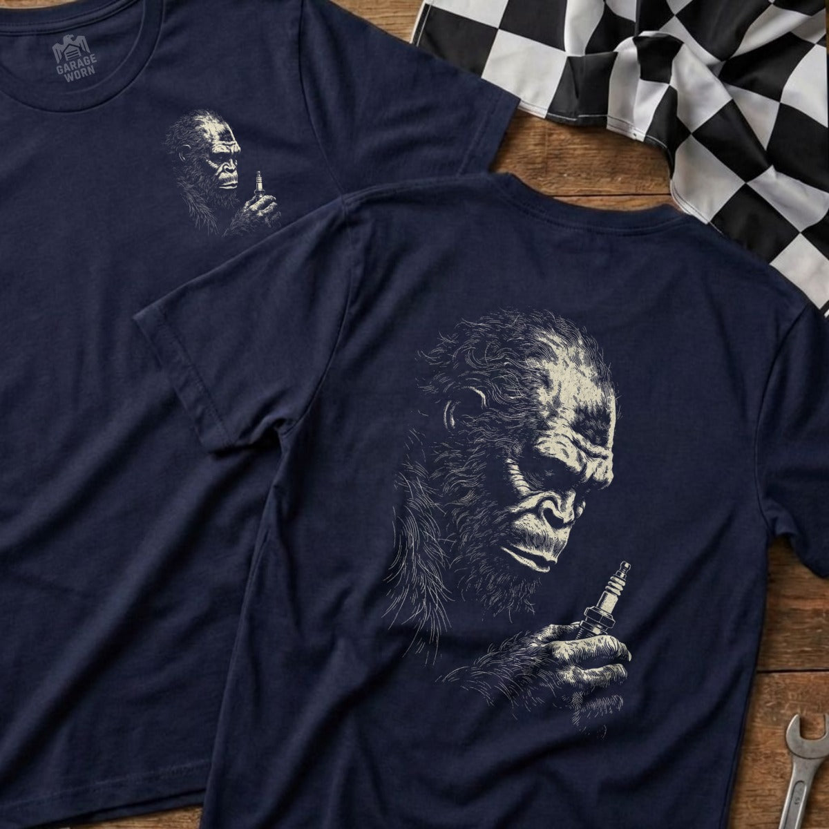 Navy t-shirt with a sketch of a gorilla holding a spark plug.