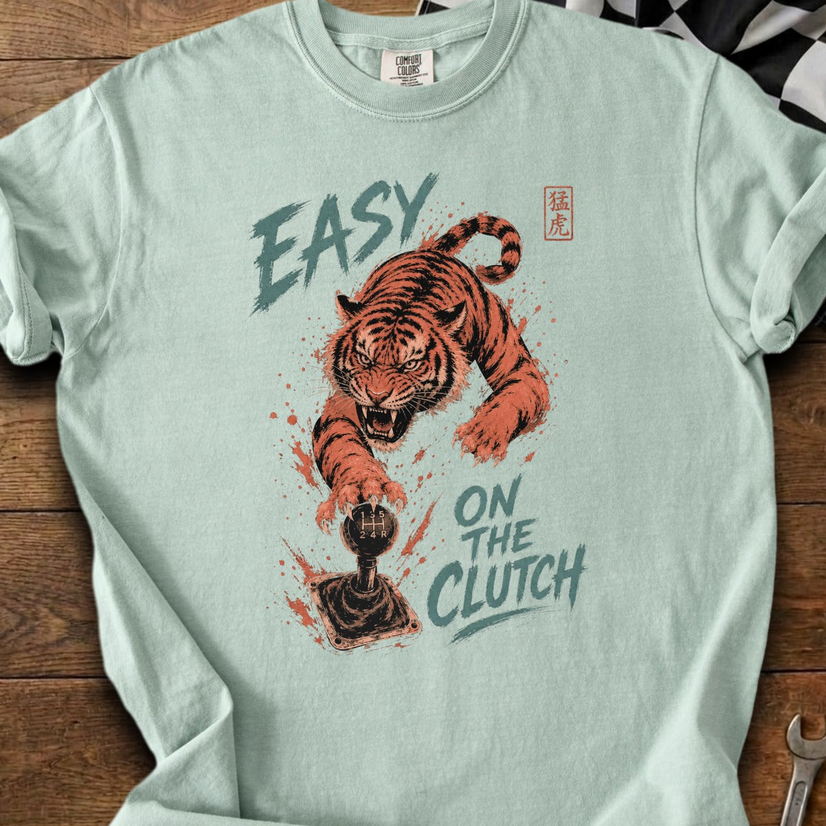 Tiger lunging for a manual transmission stick shift with text.