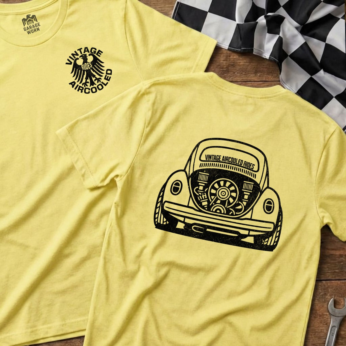 Yellow t-shirt with vintage air-cooled VW beetle engine on back.