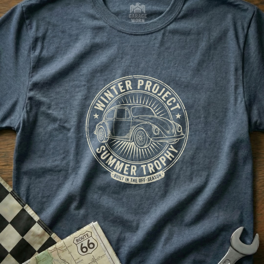 Vintage VW Beetle in circular emblem with "Winter Project Summer Trophy" text.