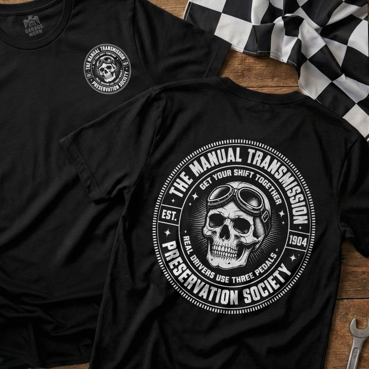 Black t-shirt with graphic of skull wearing goggles and text "Manual Transmission Preservation Society".