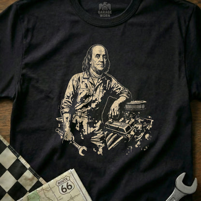Benjamin Franklin in mechanic's clothes leaning on car engine, holding a wrench.