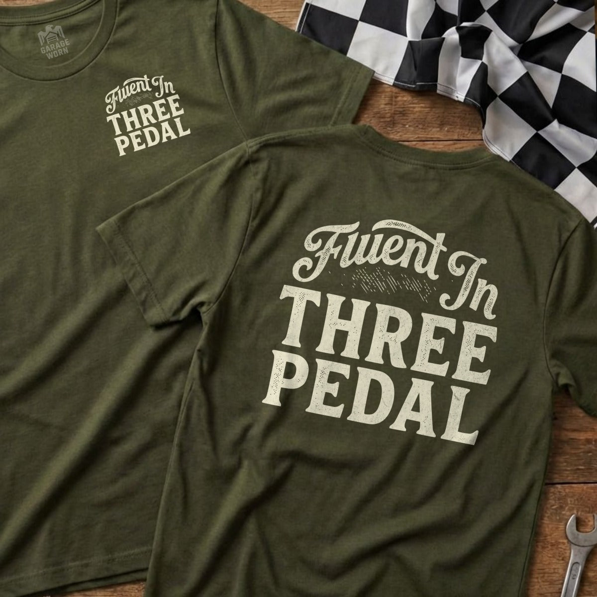 Green t-shirts with "Fluent In Three Pedal" text on back, with checkered flag.