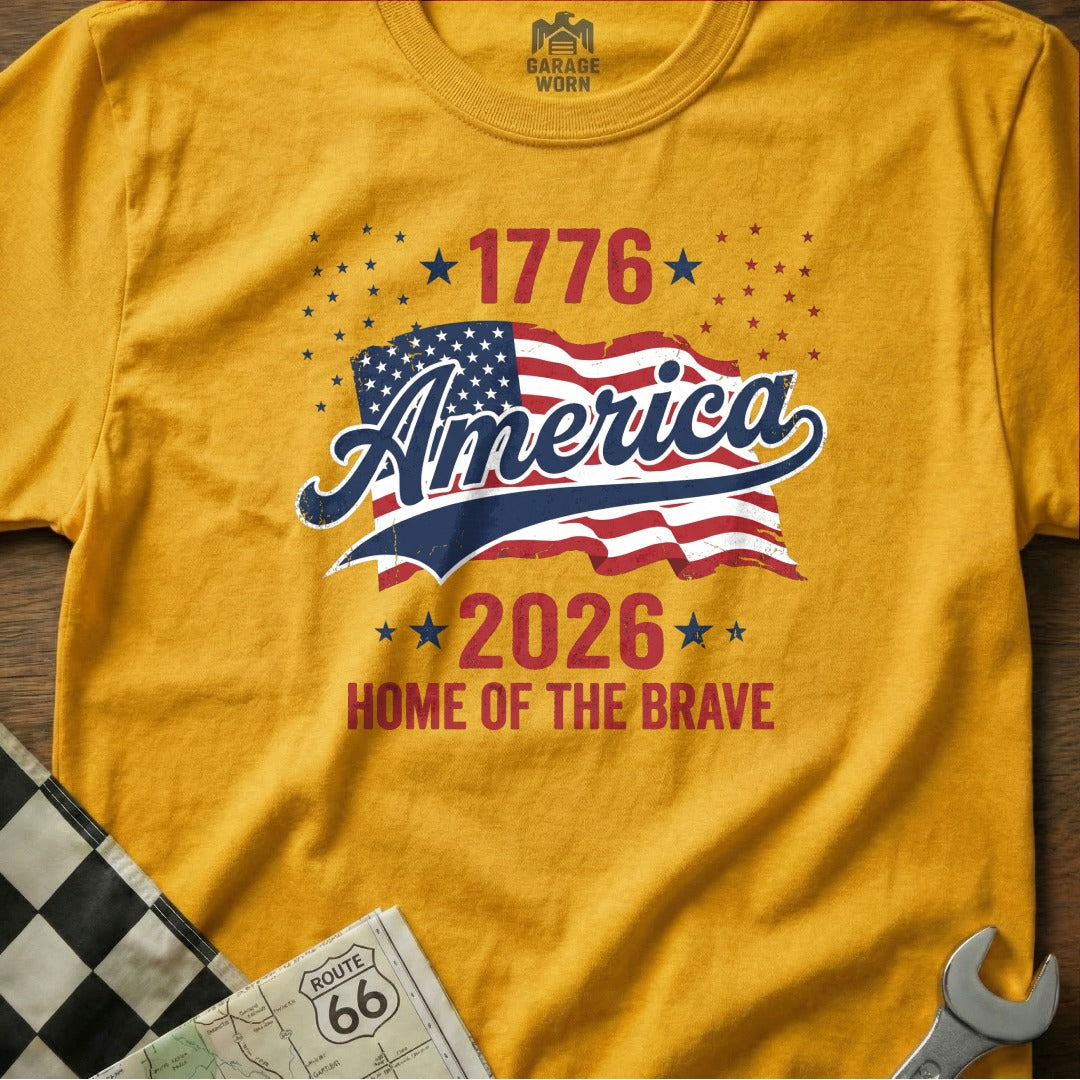 Yellow t-shirt with "1776 America 2026 Home of the Brave" and USA flag.