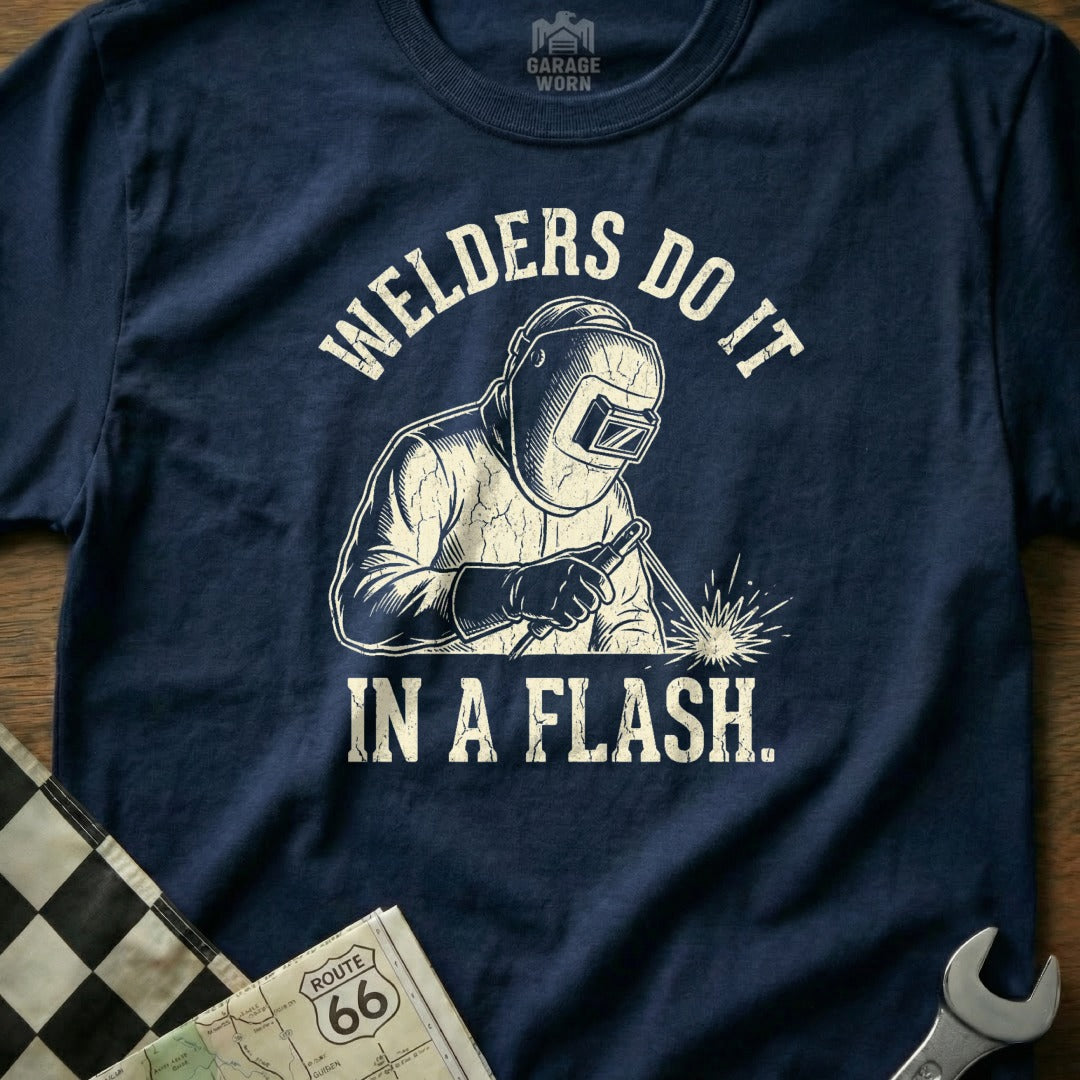 Navy t-shirt featuring a graphic of a welder and text "WELDERS DO IT IN A FLASH."