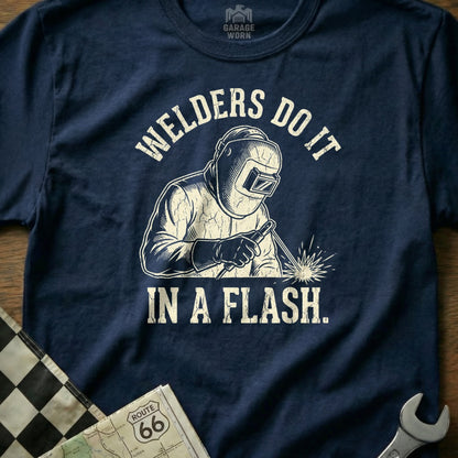 Navy t-shirt featuring a graphic of a welder and text "WELDERS DO IT IN A FLASH."