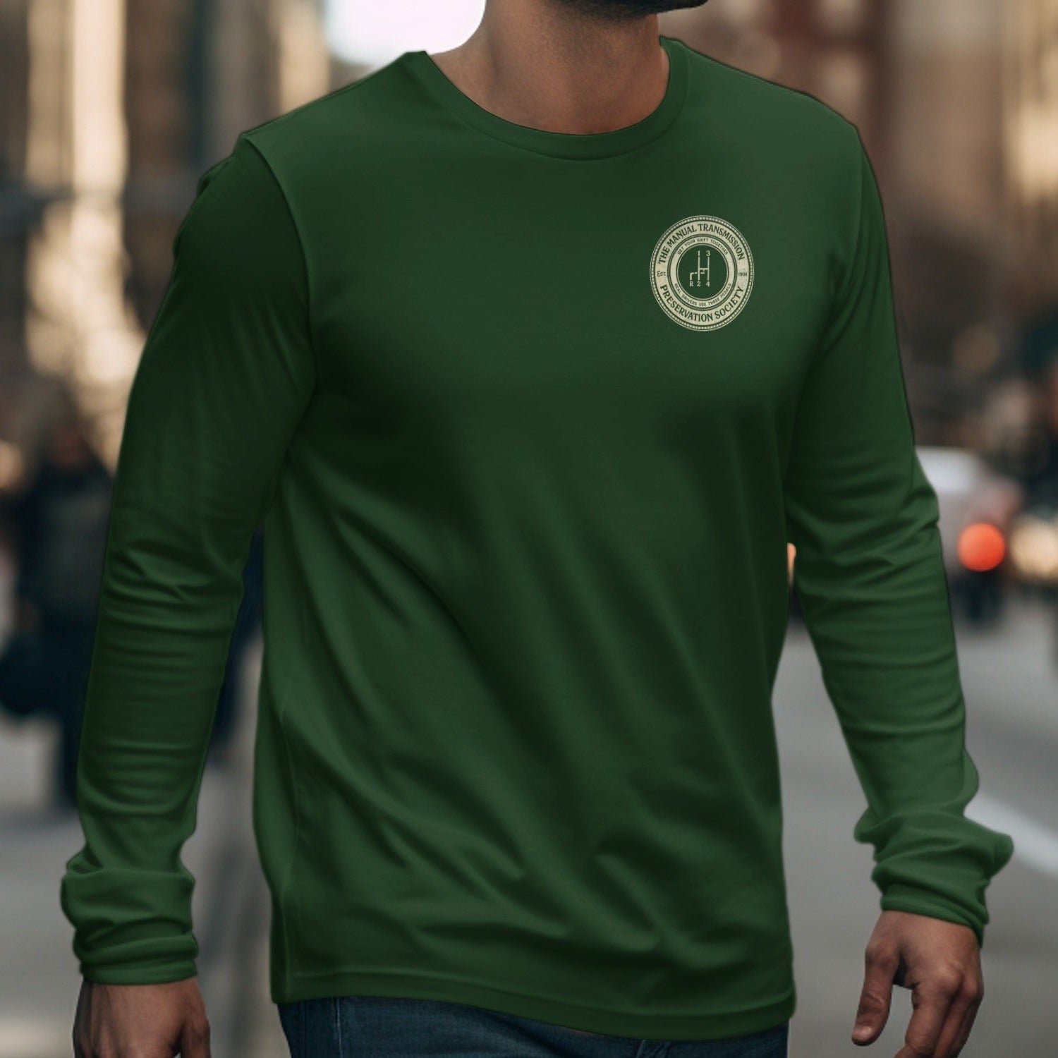 Dark green long sleeve shirt with manual transmission preservation society logo on chest.
