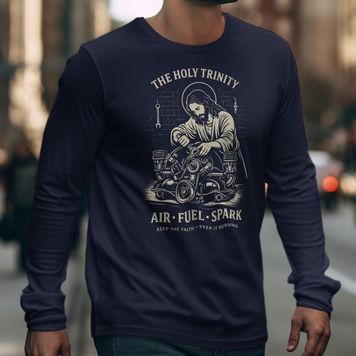 Navy long-sleeve shirt with Jesus working on an engine design; "The Holy Trinity," "Air. Fuel. Spark."