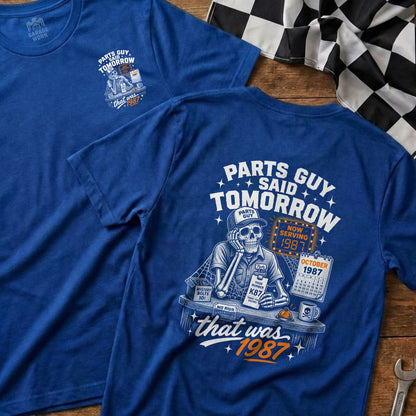 Blue t-shirt with skeleton graphic, "Parts Guy Said Tomorrow" text, and 1987 calendar.