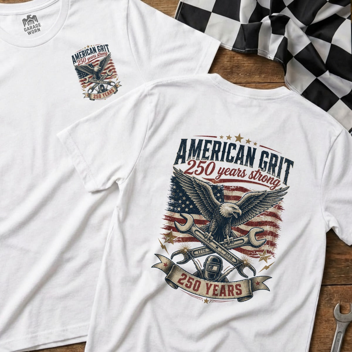 White t-shirts display "American Grit 250 years strong" with eagle, wrench, and flag graphics.