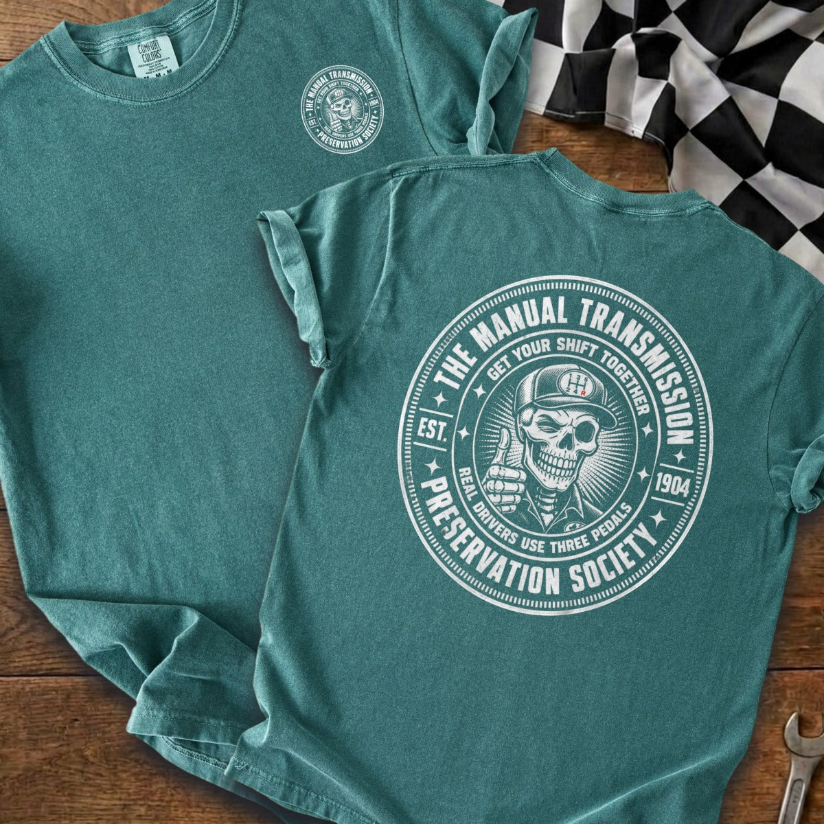 Teal t-shirt with circular "Manual Transmission Preservation Society" graphic.