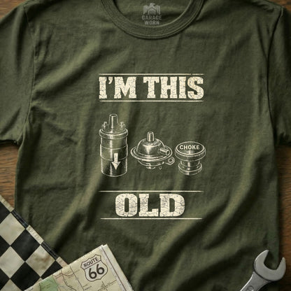 Green t-shirt with "I'm This Old" and images of car parts.