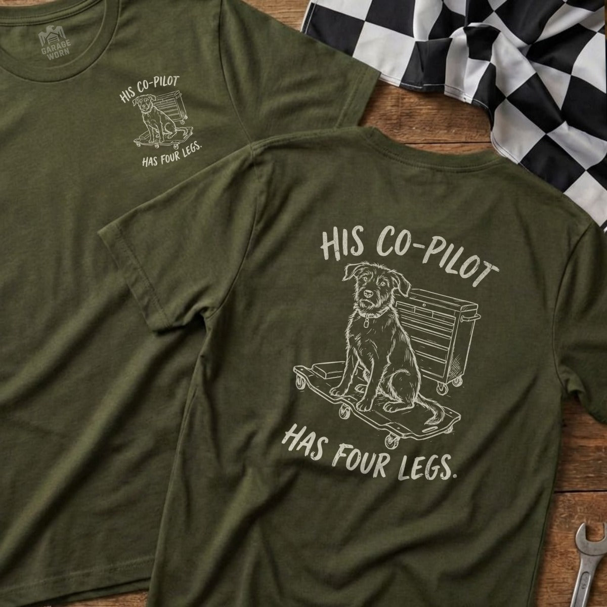 Green t-shirt with dog on skateboard graphic and text "His Co-Pilot Has Four Legs."
