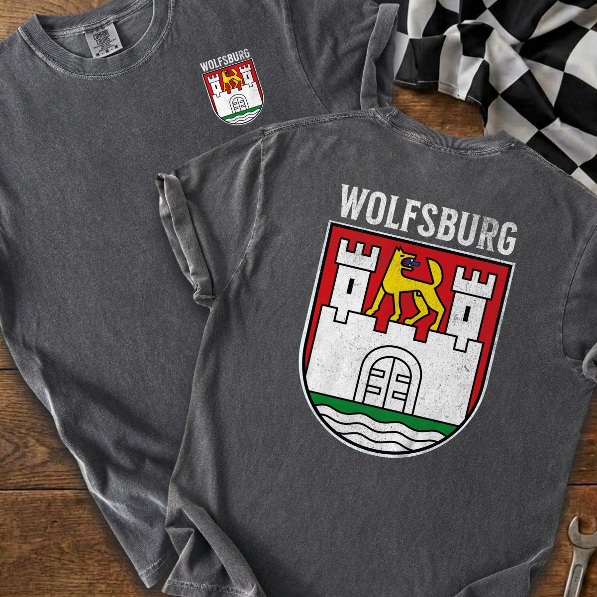 Charcoal grey t-shirts display "Wolfsburg" and a crest with a yellow wolf on a castle.