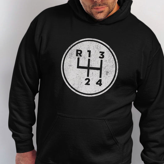 Black hoodie with a white distressed graphic of a manual car gear shift pattern.