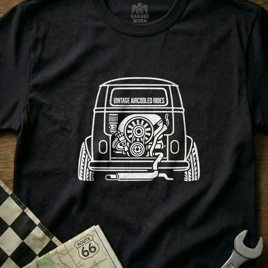 Black t-shirt with white graphic of a vintage air-cooled engine and exhaust on a bus.