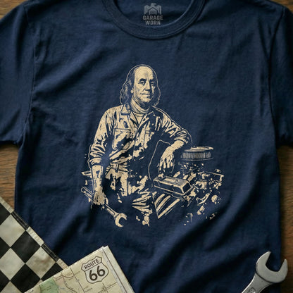 Benjamin Franklin in mechanic's clothing leans on an engine with tools.