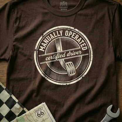 Brown t-shirt with "Manually Operated Certified Driver" circular distressed logo.