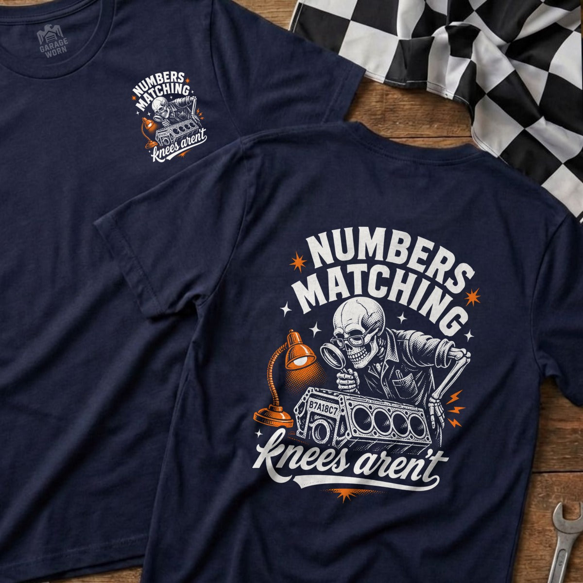 Navy t-shirt with skeleton mechanic examining engine part, text: Numbers Matching Knees Aren't.