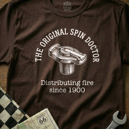 Brown t-shirt with "The Original Spin Doctor" and distributing cap graphic.